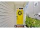 Vibrant yellow front door with a wreath, welcoming entryway, and a charming welcome mat at 9712 Fanning Basket Ln, Ladson, SC 29456
