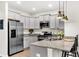 Well-equipped kitchen with granite countertops, stainless steel appliances, and ample cabinet space at 9712 Fanning Basket Ln, Ladson, SC 29456