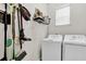 Laundry room with washer, dryer, storage shelves, and various cleaning tools at 9712 Fanning Basket Ln, Ladson, SC 29456