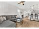 Comfortable living room with a sectional sofa, modern ceiling fan, and an open layout to the kitchen at 9712 Fanning Basket Ln, Ladson, SC 29456