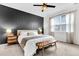 This main bedroom features a gray accent wall, ceiling fan, and bench at 9712 Fanning Basket Ln, Ladson, SC 29456