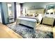 Comfortable bedroom featuring a king-size bed, decorative mirrors, and stylish rug at 101 Fresh Meadow Ln, Mount Pleasant, SC 29466