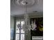 Close-up of a stunning Schonbek crystal chandelier hanging in the dining room at 101 Fresh Meadow Ln, Mount Pleasant, SC 29466