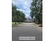 A scenic view of the Dunes West Clubhouse with manicured lawns and mature trees offers a glimpse of community amenities at 101 Fresh Meadow Ln, Mount Pleasant, SC 29466
