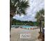 A luxurious resort-style community pool with ample lounge chairs and swaying palm trees offers a relaxing oasis at 101 Fresh Meadow Ln, Mount Pleasant, SC 29466