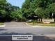 A lush tree-lined neighborhood entrance with brick signage creates a serene welcoming to Egrets Walk at 101 Fresh Meadow Ln, Mount Pleasant, SC 29466