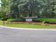 A community sign surrounded by beautiful flowers and lush landscaping welcomes residents and guests to Dunes West at 101 Fresh Meadow Ln, Mount Pleasant, SC 29466