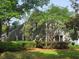 Angle view of a beautiful home with gray wood siding and lush, green landscaping around the perimeter at 101 Fresh Meadow Ln, Mount Pleasant, SC 29466