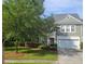 Charming two-story home with a well-manicured front yard and attached two-car garage at 101 Fresh Meadow Ln, Mount Pleasant, SC 29466