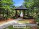 A charming wooden gazebo near a lake offers a serene retreat surrounded by lush greenery and tranquil scenery at 101 Fresh Meadow Ln, Mount Pleasant, SC 29466