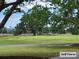 A lush green golf course with mature trees offers a picturesque recreational amenity for residents and golf enthusiasts at 101 Fresh Meadow Ln, Mount Pleasant, SC 29466