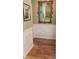 Hallway featuring pristine hardwood floors, white wainscoting, and ornate framed mirror at 101 Fresh Meadow Ln, Mount Pleasant, SC 29466