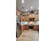 Modern kitchen with stainless steel appliances, wood cabinets, wood floors, and granite countertops at 101 Fresh Meadow Ln, Mount Pleasant, SC 29466