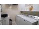Functional laundry room with washer, dryer, cabinets, and convenient shelving at 101 Fresh Meadow Ln, Mount Pleasant, SC 29466