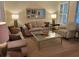 Comfortable living room with sofas, a decorative mirror, lamps, and natural light at 101 Fresh Meadow Ln, Mount Pleasant, SC 29466