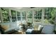 Bright sunroom with lots of windows and wicker furniture for relaxing and enjoying the view at 101 Fresh Meadow Ln, Mount Pleasant, SC 29466