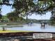 A peaceful water view from Dunes West Clubhouse lawn with a dock offers a serene escape and picturesque scenery at 101 Fresh Meadow Ln, Mount Pleasant, SC 29466