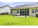 A large backyard of a home with healthy lawn, a patio, a house, and fencing at 106 Chedburg Dr, Goose Creek, SC 29445