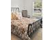 Comfortable bedroom with large window, classic iron bed frame, and floral bedding at 106 Chedburg Dr, Goose Creek, SC 29445