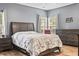 Primary bedroom featuring a large bed, hardwood floors, dresser, and bright windows at 106 Chedburg Dr, Goose Creek, SC 29445