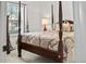 Bedroom featuring a beautiful four-poster bed, neutral decor, and large bright window at 106 Chedburg Dr, Goose Creek, SC 29445