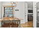 Cozy dining room with hardwood floors, built-in hutch, natural light, and an adjoining living area at 106 Chedburg Dr, Goose Creek, SC 29445
