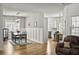 Open dining area with hardwood floors, decorative wainscoting, and modern chandelier adjacent to the white kitchen at 106 Chedburg Dr, Goose Creek, SC 29445