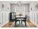 Modern dining room with wood floors, wainscoting, and a large window providing lots of natural light at 106 Chedburg Dr, Goose Creek, SC 29445