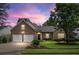 Charming brick home with a well-manicured lawn and a two-car garage under a beautiful sunset sky at 106 Chedburg Dr, Goose Creek, SC 29445