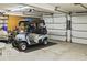 Spacious garage featuring an open overhead door, a golf cart, and ample storage space at 106 Chedburg Dr, Goose Creek, SC 29445