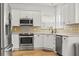 Bright kitchen with stainless steel appliances, white cabinets, tile backsplash, and light countertops at 106 Chedburg Dr, Goose Creek, SC 29445