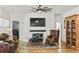 Open-concept living area features a marble fireplace, wood floors, ceiling fan, and comfortable seating at 106 Chedburg Dr, Goose Creek, SC 29445