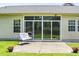 Home's outdoor concrete patio with a chair, lawn, pots with flowers, and sliding doors to home at 106 Chedburg Dr, Goose Creek, SC 29445