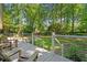 View from the back deck showcasing the lush backyard, mature trees, and seating, perfect for outdoor relaxation at 1061 Law Ln, Mount Pleasant, SC 29464