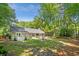 Spacious backyard featuring a lush lawn, patio with seating, and mature trees, perfect for outdoor enjoyment and relaxation at 1061 Law Ln, Mount Pleasant, SC 29464