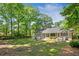 Expansive backyard with lush lawn, mature trees, patio, and outdoor seating, perfect for entertaining and relaxation at 1061 Law Ln, Mount Pleasant, SC 29464