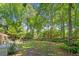 Lush backyard showcasing a well-manicured lawn, mature trees, patio and various seating areas perfect for relaxation at 1061 Law Ln, Mount Pleasant, SC 29464