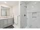 Bathroom with marble tiling, shower, modern sink, gray cabinets, and a neutral color palette at 1061 Law Ln, Mount Pleasant, SC 29464