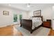 Bedroom with a sleigh bed, wooden floors, ceiling fan, and doors to backyard at 1061 Law Ln, Mount Pleasant, SC 29464