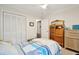 Bright bedroom featuring a patterned comforter, closet, and vintage wood cabinet at 1061 Law Ln, Mount Pleasant, SC 29464