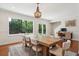 Dining room with hardwood floors, a stylish light fixture, and backyard view at 1061 Law Ln, Mount Pleasant, SC 29464