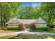 Charming home featuring a lush, landscaped front yard with mature trees and a circular driveway at 1061 Law Ln, Mount Pleasant, SC 29464