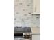 Close up of marble backsplash and stainless steel oven and range at 1061 Law Ln, Mount Pleasant, SC 29464