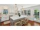 Bright kitchen features white cabinets, marble backsplash, stainless appliances, and an island with stools at 1061 Law Ln, Mount Pleasant, SC 29464
