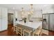 Bright kitchen features white cabinets, marble backsplash, stainless appliances, and an island with stools at 1061 Law Ln, Mount Pleasant, SC 29464