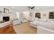 Bright living room with hardwood floors, fireplace, ceiling fan, and comfortable white furniture at 1061 Law Ln, Mount Pleasant, SC 29464
