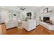 Spacious living room featuring bright white decor, brick fireplace and a hardwood floor at 1061 Law Ln, Mount Pleasant, SC 29464