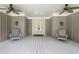 Relaxing front porch with ceiling fans and seating, perfect for enjoying the outdoors at 1061 Law Ln, Mount Pleasant, SC 29464