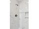 Close up of shower with white marble tiling, a shower head, and decorative niche at 1061 Law Ln, Mount Pleasant, SC 29464