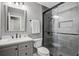 This is a modern bathroom featuring a glass-enclosed shower and sleek gray vanity with a sink at 110 Terry Ave, Summerville, SC 29485